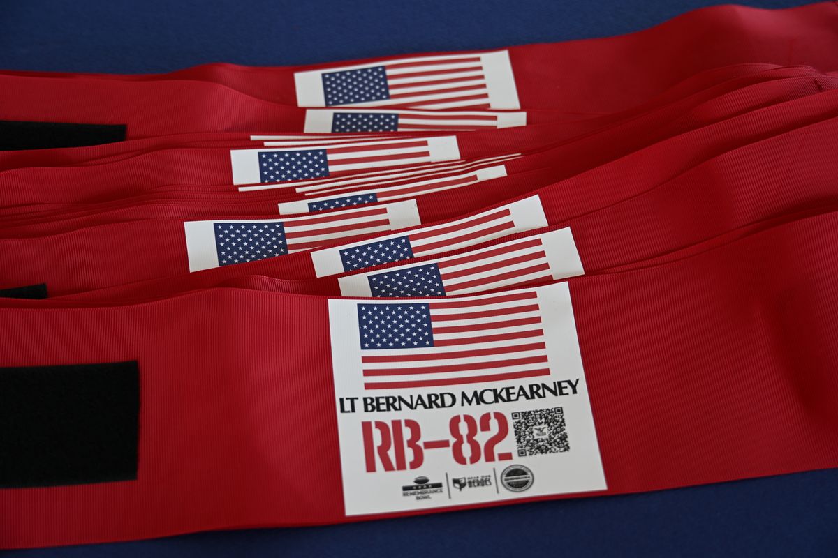 Remembrance Bowl armbands, including one for LT Bernard McKearney, with a QR code to his Memorial of Valor